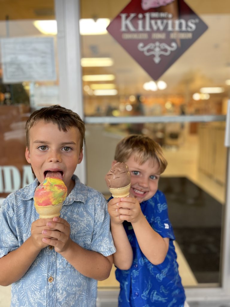 Boys eating ice cream in front of Kilwin's. 