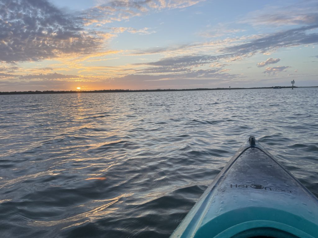 Sunset over a kayak in Rookery Bay in Naples, FL